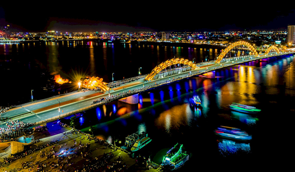 Capture the moment of the Dragon Bridge's fire-breathing show from a drone